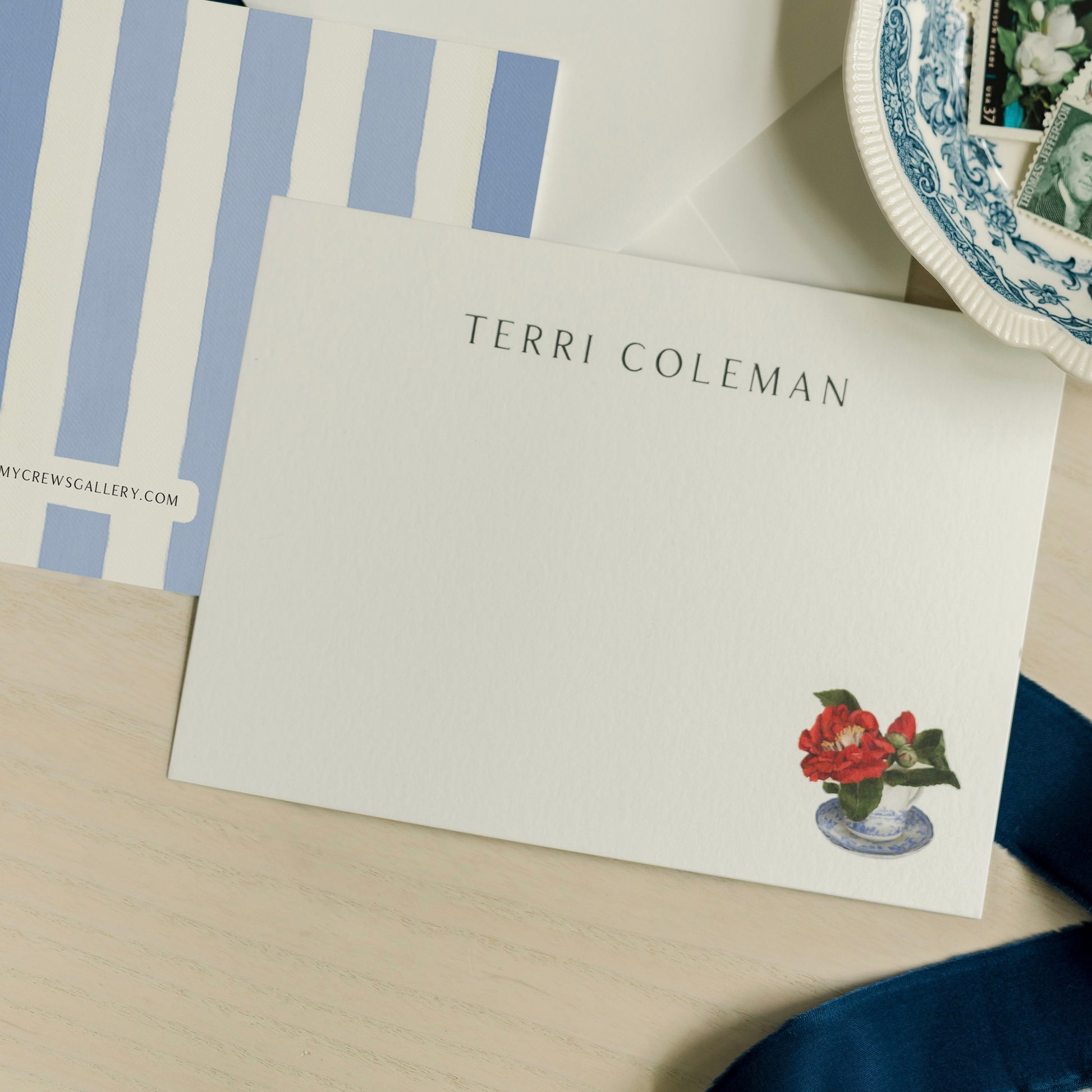 Note card with floral design and 'Terri Coleman' text on a wooden surface  - Amy Crews Art